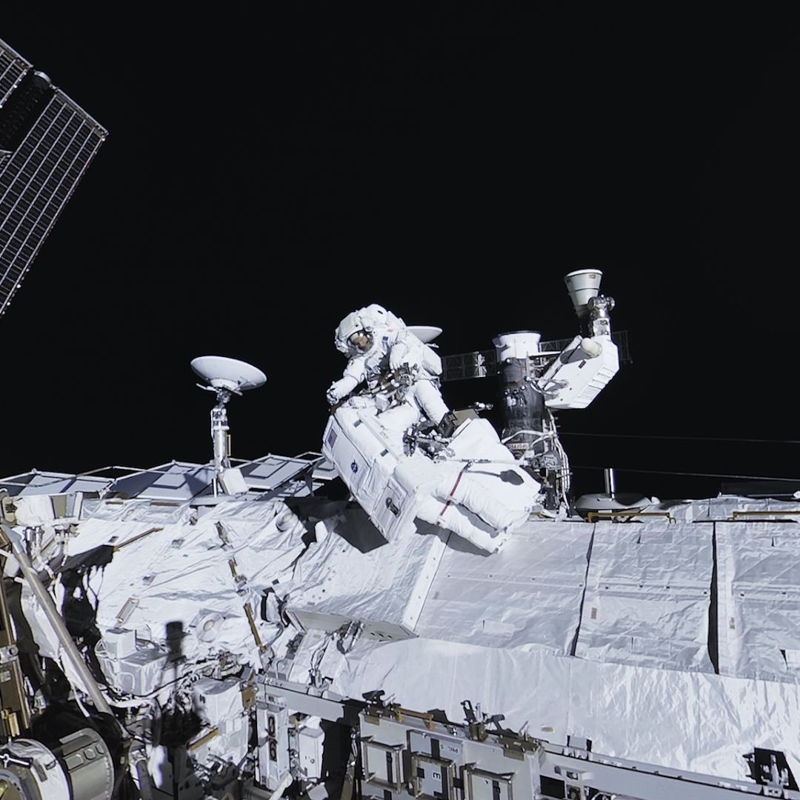Two astronauts on a spacewalk captured by a Felix & Paul Studios camera.